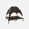 Outdoor elevated dog bed with canopy, brown breathable mesh platform, black metal frame, portable pet shade bed for camping and patio use