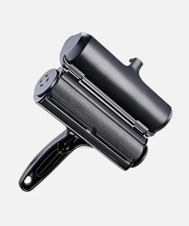 Black dog hair remover roller on plain white background